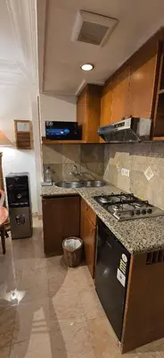 a kitchen with a stove and a sink at The Palmana Courtyard Jayakarta Residence 6 in Seminyak