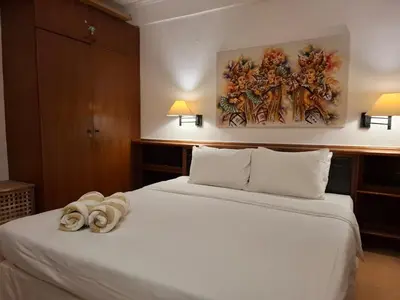 a hotel room with a bed with towels on it at The Palmana Courtyard Jayakarta Residence 6 in Seminyak