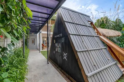 an entrance to a house with a black wall at Incredible Family villa with water slide Beachside in Sanur