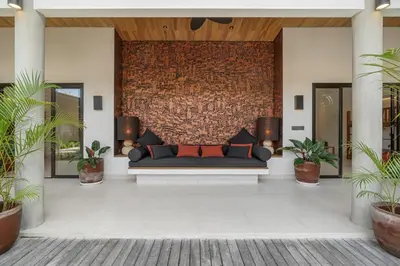 a couch sitting in a lobby with plants at Incredible Family villa with water slide Beachside in Sanur