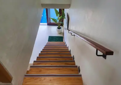 a staircase leading up to a room with a potted plant at Villa Casanomi By Pandara in Kerobokan