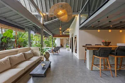 a living room with a couch and a table at Villa Surga Kecil Seminyak in Seminyak