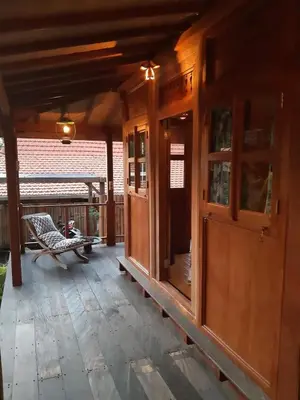 a porch of a house with a bench on it at Desa Biasa in Kerobokan