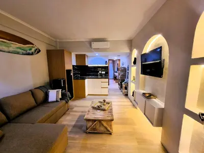 a living room with a couch and a table at Mana Suites Bali in Kuta