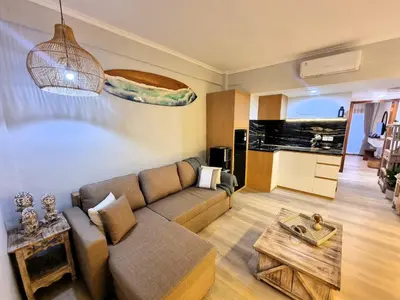 a living room with a couch and a table at Mana Suites Bali in Kuta