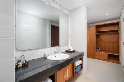 a bathroom with a sink and a mirror at Vansari Serenity Villa in Seminyak