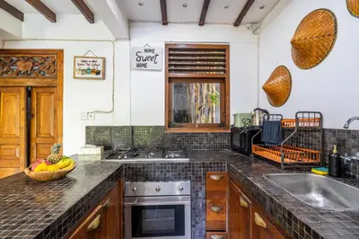a kitchen with a sink and a counter top at Bali Dream Villa Legian by iBali Management in Seminyak