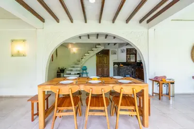 a dining room with a wooden table and chairs at Bali Dream Villa Legian by iBali Management in Seminyak