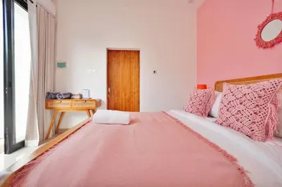 a bedroom with a bed with a pink blanket at Robelle Villa by iBali Management in Seminyak