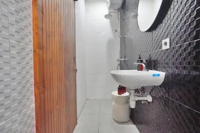 a bathroom with a sink and a toilet at Robelle Villa by iBali Management in Seminyak