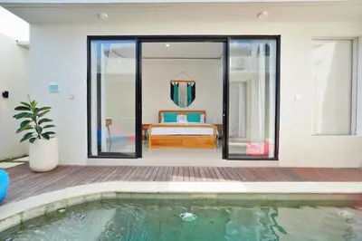 a bedroom with a pool and a bed in a house at Robelle Villa by iBali Management in Seminyak
