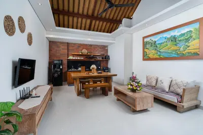 a living room with a couch and a table at Honeymoon Villa Aisha in The Heart of Legian in Seminyak
