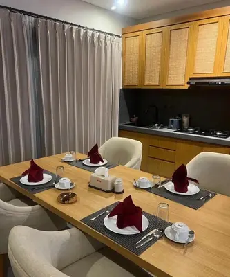 a wooden table with red hats on top of it at Villa Dharman Jimbaran in Jimbaran