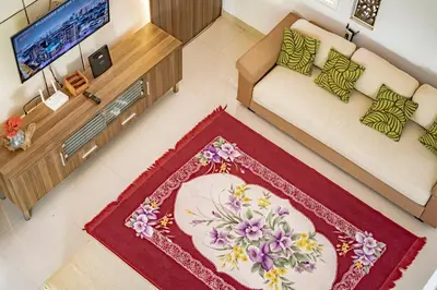 an overhead view of a living room with a couch and a rug at Casa Raya 4BR Villa in Kuta in Kuta