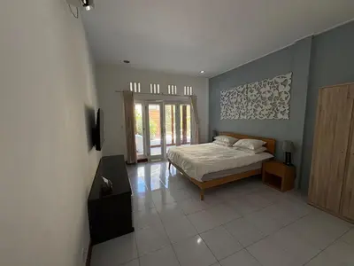 a bedroom with a bed and a window at Villa central seminyak in Seminyak