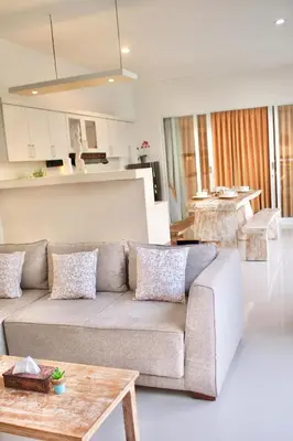 a living room with a couch and a kitchen at Villa 2BR Seminyak 8mins Beach in Seminyak