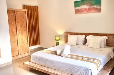a bedroom with a large bed with white sheets at Villa 2BR Seminyak 8mins Beach in Seminyak
