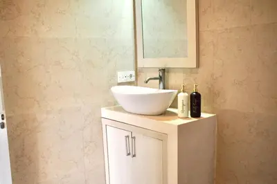 a bathroom with a white sink and a mirror at Villa 2BR Seminyak 8mins Beach in Seminyak