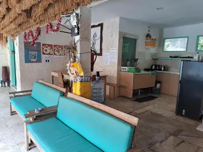 a room with blue benches and a kitchen at Lavender Villa 7 Moon House in Kuta