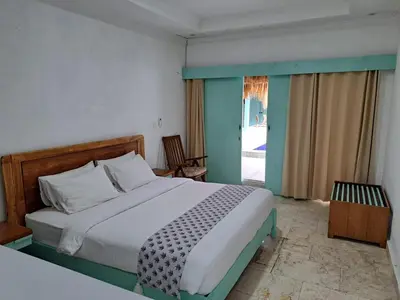 a bedroom with a large bed and a window at Lavender Villa 7 Moon House in Kuta