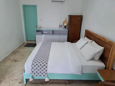 a bedroom with a large bed with a blue and white bed sidx sidx at Lavender Villa 7 Moon House in Kuta