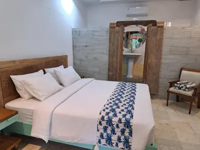 a bedroom with a bed and a sink in it at Lavender Villa 7 Moon House in Kuta