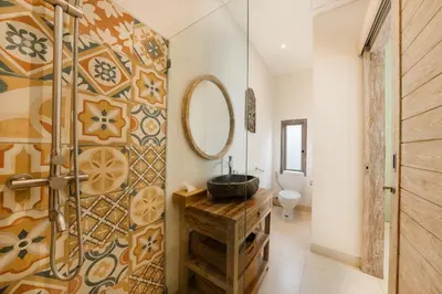 a bathroom with a sink and a mirror at Villa Anna Lou 1BR Boho Escape in Seminyak in Seminyak