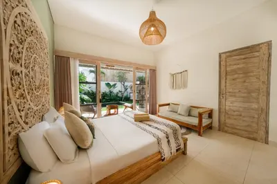 a bedroom with a large bed and a window at Villa Anna Lou 1BR Boho Escape in Seminyak in Seminyak