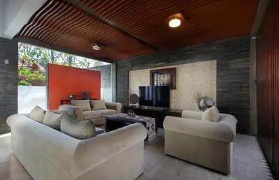 a living room with couches and a flat screen tv at Djayana Villa Seminyak in Seminyak