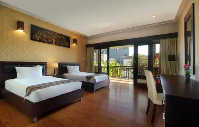 a hotel room with two beds and a balcony at Djayana Villa Seminyak in Seminyak