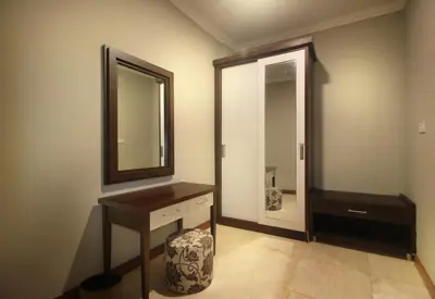 a bathroom with a sink and a mirror and a stool at Djayana Villa Seminyak in Seminyak