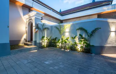 a house with a courtyard with potted plants at Villa Sakura Nisa in Seminyak