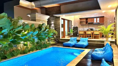 a swimming pool in the middle of a room with a kitchen at Villa Sakura Nisa in Seminyak