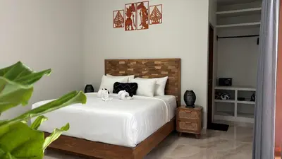 a bedroom with a bed with two stuffed animals on it at Villa Sakura Nisa in Seminyak