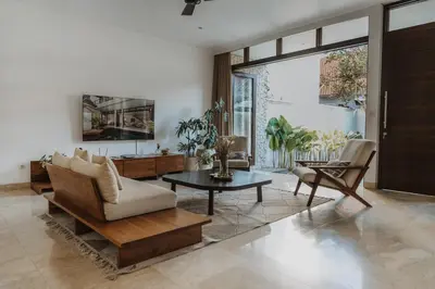 a living room with a couch and chairs and a table at Villa Casa Rumi in Canggu