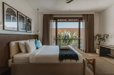a bedroom with a bed and a large window at Villa Casa Rumi in Canggu