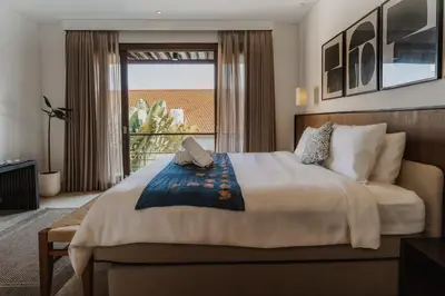 a bedroom with a large bed and a large window at Villa Casa Rumi in Canggu
