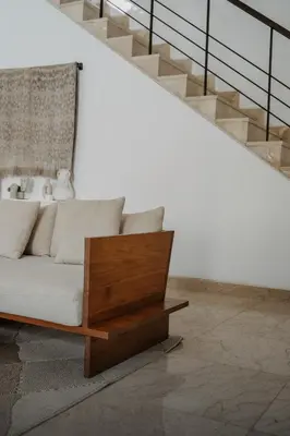 a living room with a white couch and stairs at Villa Casa Rumi in Canggu