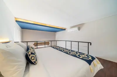 a bedroom with a large white bed with white pillows at First 5 Bedrooms Villa in Seminyak