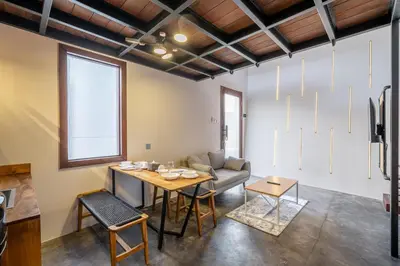a living room with a table and a couch at First 5 Bedrooms Villa in Seminyak