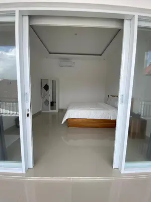 a bedroom with a bed in the middle of a room at Hidden Homestay Jimbaran in Jimbaran