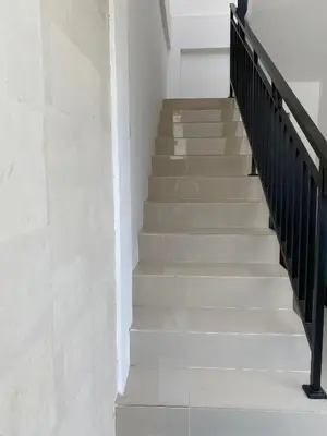 a staircase in a building with white walls at Hidden Homestay Jimbaran in Jimbaran