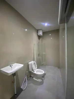 a bathroom with a toilet and a sink at Hidden Homestay Jimbaran in Jimbaran