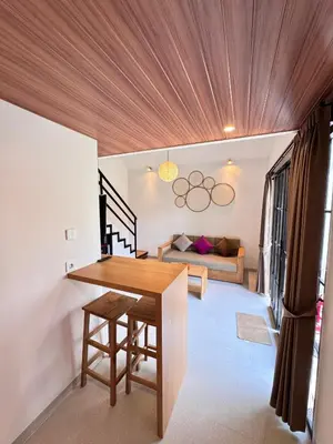 a dining room with a table and a couch at Kubumanik Loft in Seminyak