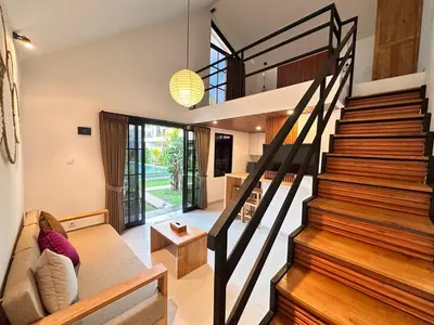 a modern house with a staircase and a living room at Kubumanik Loft in Seminyak