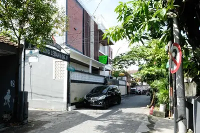 a car parked in front of a building on a street at Urbanview Hotel Arta Guna Casa in Kerobokan