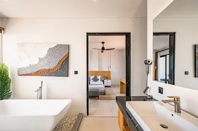 a bathroom with two sinks and a large mirror at Aya Townhouses - Prime Location Umalas in Kerobokan