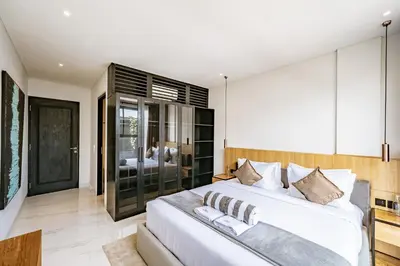 a bedroom with a large white bed in a room at Aya Townhouses - Prime Location Umalas in Kerobokan