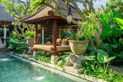 a gazebo with a bench next to a pool at Sweet Surrender - Stylish 4BR Near Potato Head in Seminyak