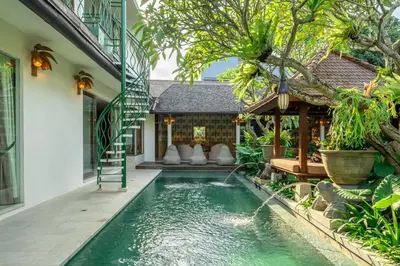 a swimming pool in the backyard of a villa at Sweet Surrender - Stylish 4BR Near Potato Head in Seminyak